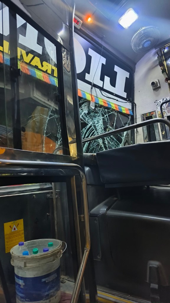 View from inside the sleeper bus after the collision, showing damaged front glass
